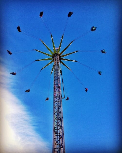 A close-up shot of a radio tower against a blue sky, with faint musical notes floating around it. This symbolizes the transmission of StayC's music into the American airwaves.