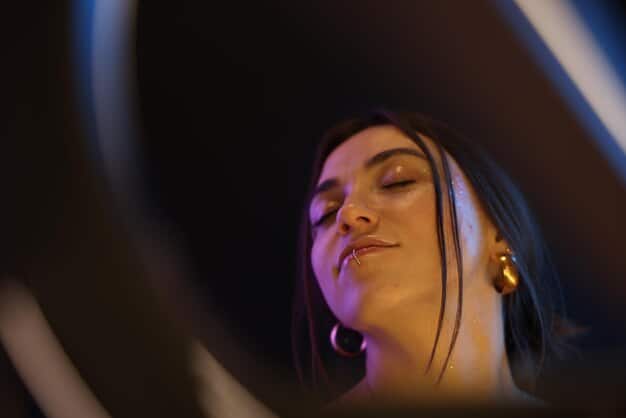 A close-up shot of one of the Billlie members during a music video shoot, emphasizing their expressive eyes and conveying the emotional depth of their performance.