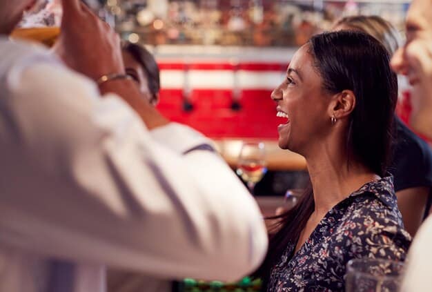 A candid photo of a Kep1er member interacting with fans during a meet-and-greet event. She is smiling and making eye contact, creating a personal and warm connection. The background shows a crowd of fans eager to engage with her. This image exemplifies her approachability and popularity among her supporters.