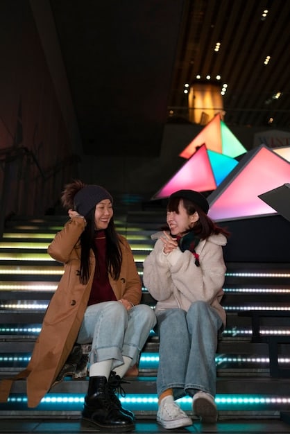 A K-Pop group performing on a brightly lit stage in the US, surrounded by cheering fans holding light sticks. The idols are energetically engaged in their choreography, with microphones in hand, showcasing their performance skills.