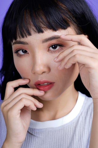 A close-up shot of a K-Pop idol's face, showcasing their flawless skin, double eyelid surgery, and styled makeup.