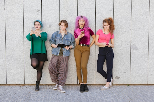 A collage of popular K-Pop inspired outfits worn by US teenagers, showcasing a mix of streetwear, colorful fabrics, and unique accessories. Show outfits inspired by groups like BLACKPINK or BTS.