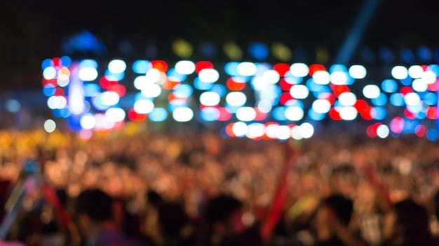 A close-up image of an ecstatic crowd at a J-Pop concert in Los Angeles, focusing on the diverse faces of American fans holding personalized banners and light sticks.