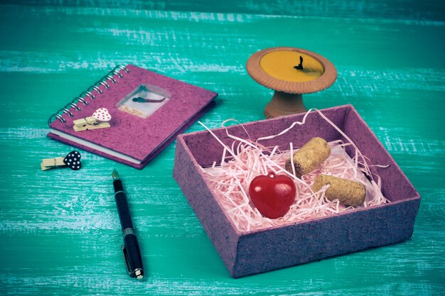A close-up, detailed shot of various J-Pop subscription box items laid out on a table, including a CD album, a colorful keychain, a small plush toy, and a Japanese snack, with emphasis on the details and vibrant colors of each item and the focus on the CD for a J-Pop theme