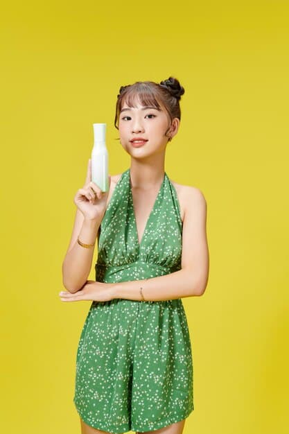 Cha Eun-woo on a brightly lit set, posing confidently for a cosmetic brand advertisement, holding a small product bottle with a refined gesture.