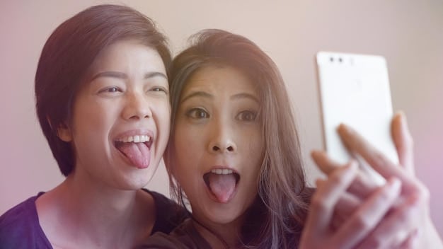A fan on a video call with a K-Pop idol, showing a screen split between the fan's excited face and the idol smiling, representing a successful fan call event.